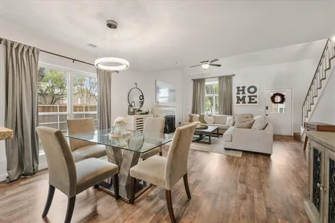 a view of a dining room with furniture wooden floor and chandelier