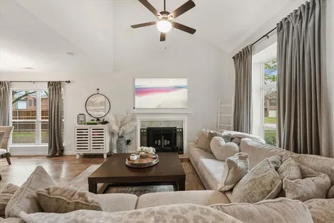 a living room with furniture chandelier and a fireplace