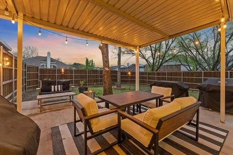 a view of a chairs and table in the patio