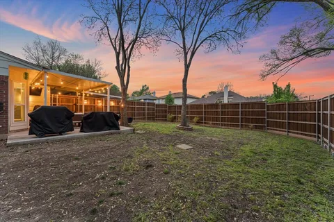 a view of backyard with wooden fence