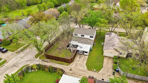 an aerial view of a house with a yard and trees