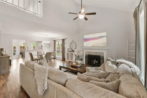 a living room with furniture a fireplace and a chandelier