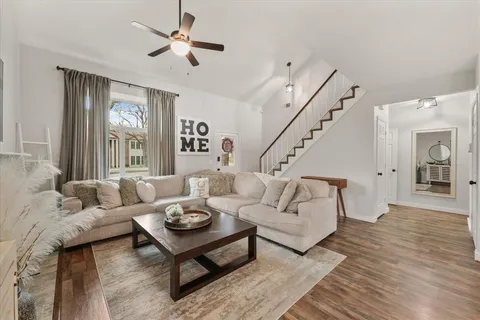 a living room with furniture and wooden floor