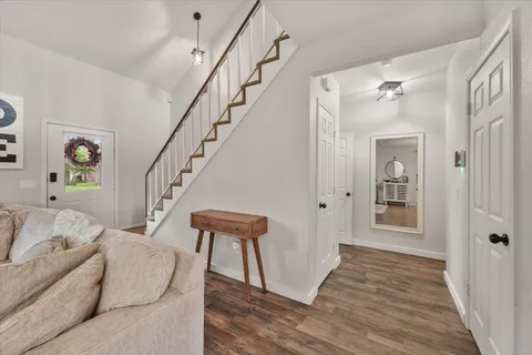a living room with furniture and a wooden floor