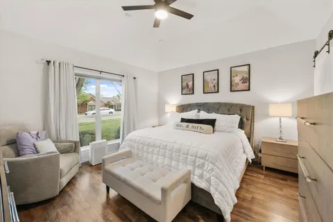 a bedroom with a bed a couch and a window