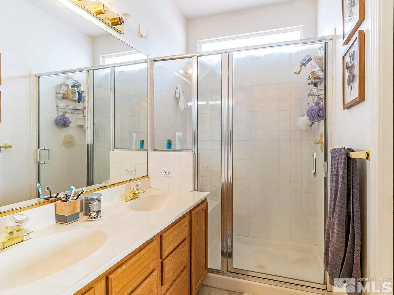875 Caughlin Crossing Reno, NV 89519 - Photo 12 of 21 a bathroom with a granite countertop shower sink and mirror