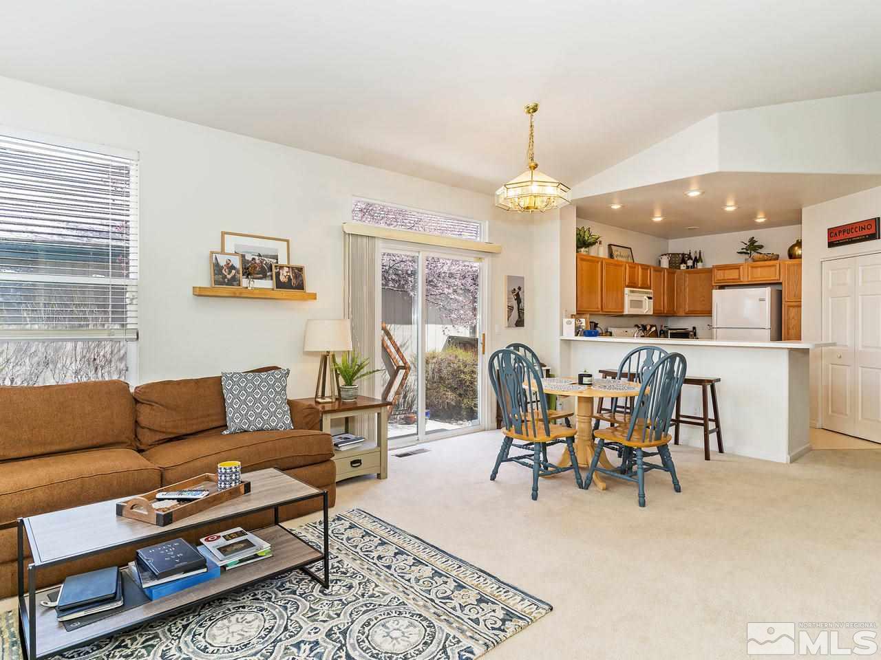 875 Caughlin Crossing Reno, NV 89519 - Photo 7 of 21 a living room with furniture and a chandelier