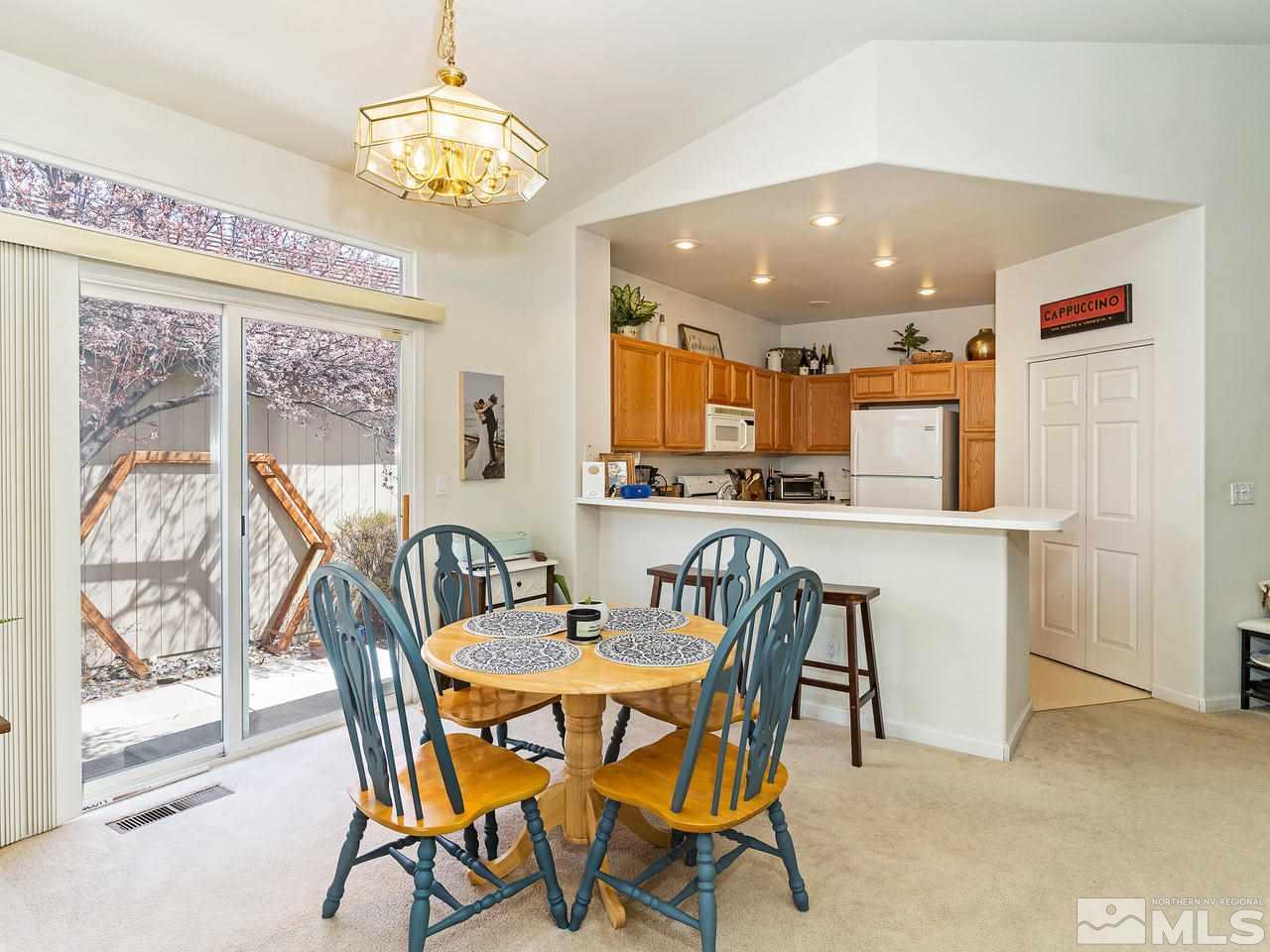 875 Caughlin Crossing Reno, NV 89519 - Photo 8 of 21 a view of a dining room with furniture and a chandelier