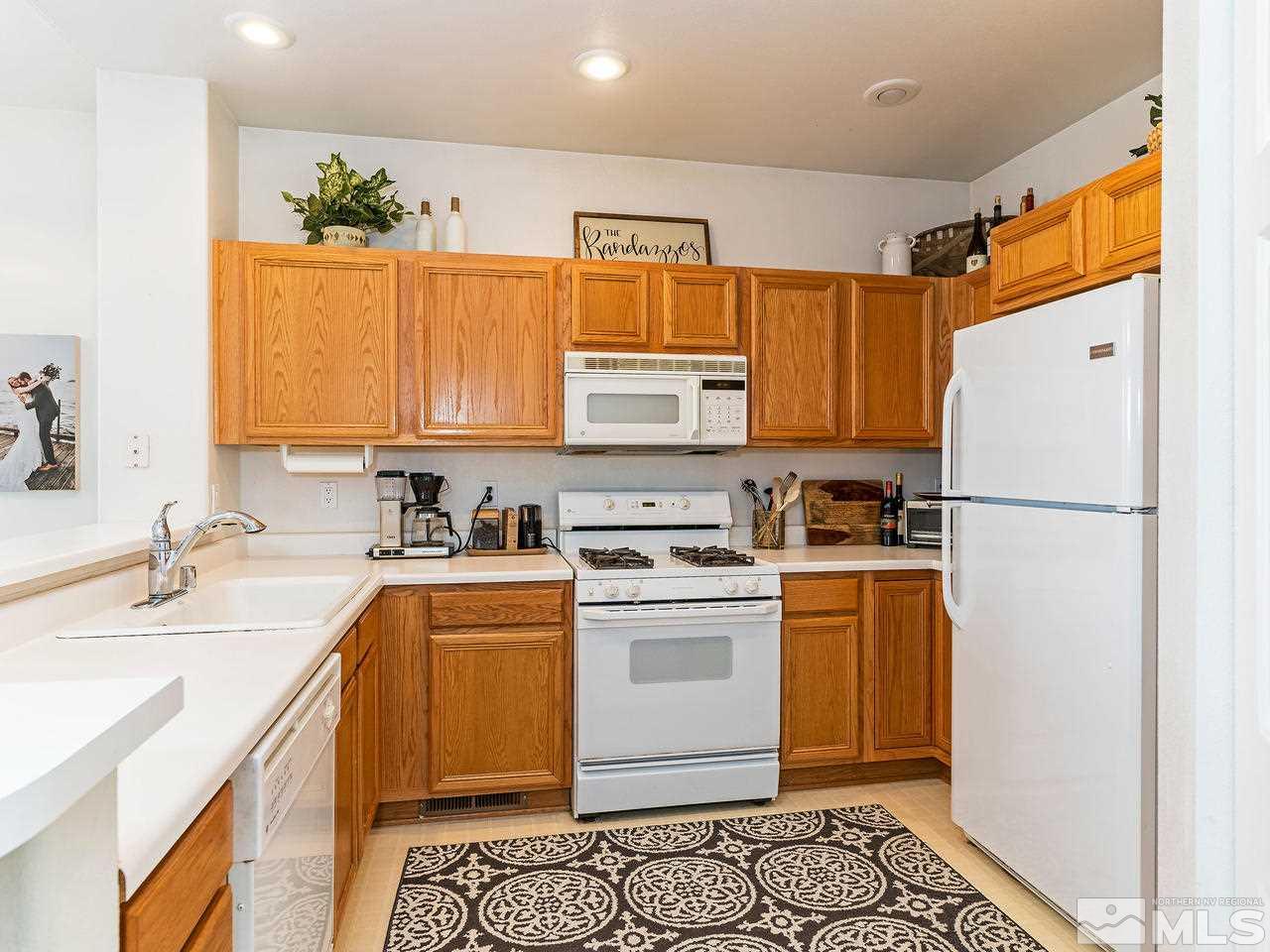 875 Caughlin Crossing Reno, NV 89519 - Photo 10 of 21 a kitchen with a refrigerator and a sink