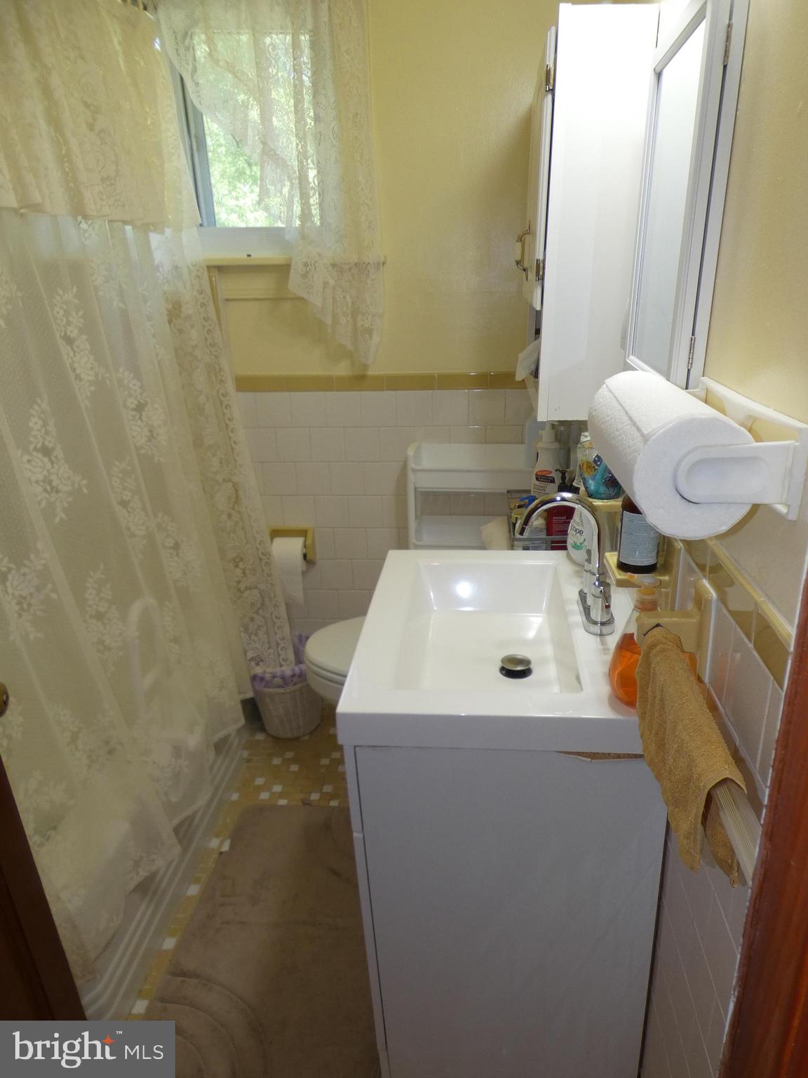 9517 Brock Road Spotsylvania, VA 22553 - Photo 13 of 27 a bathroom with a sink a toilet and a mirror