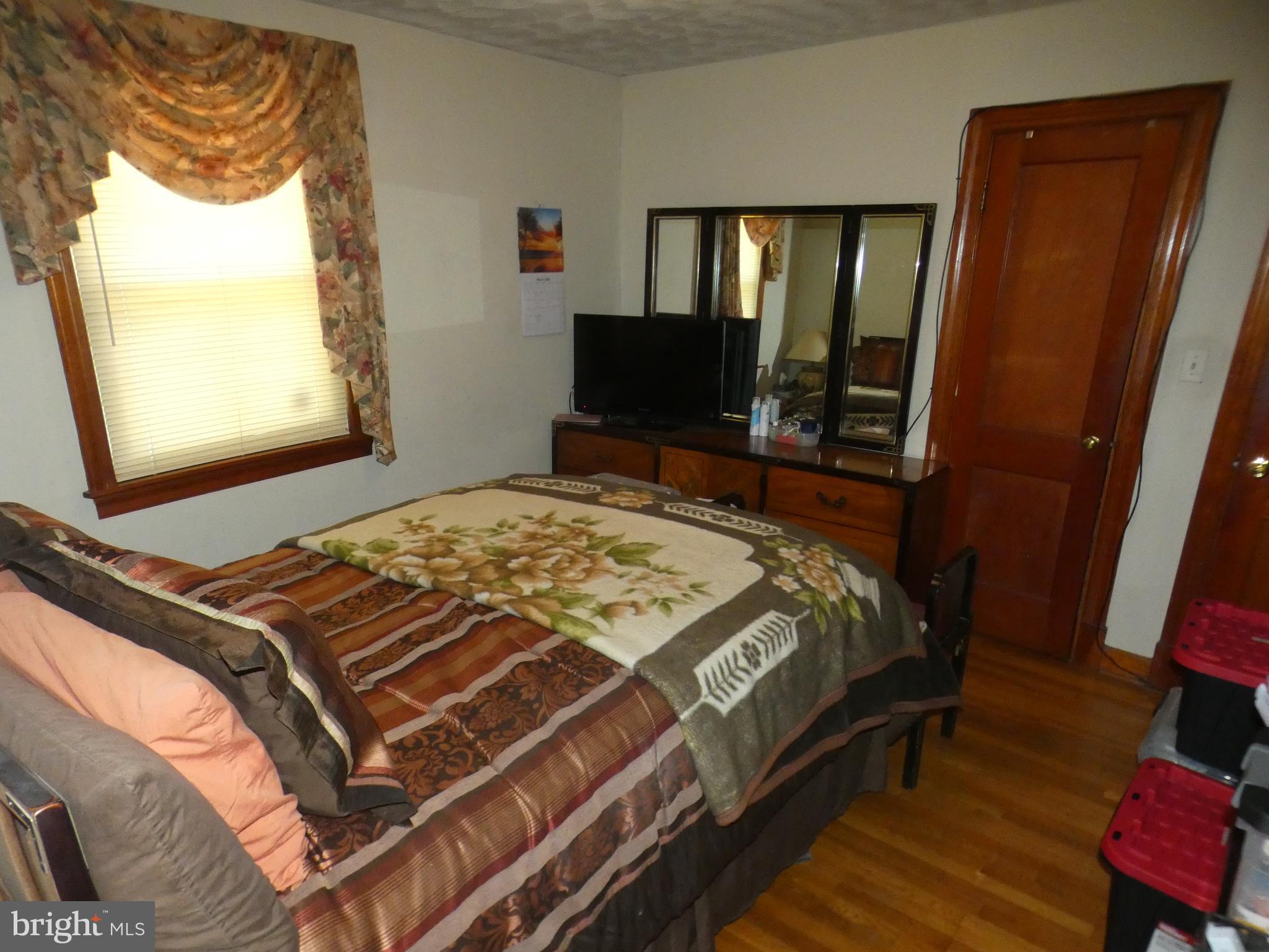 9517 Brock Road Spotsylvania, VA 22553 - Photo 15 of 27 a bedroom with a bed and a mirror