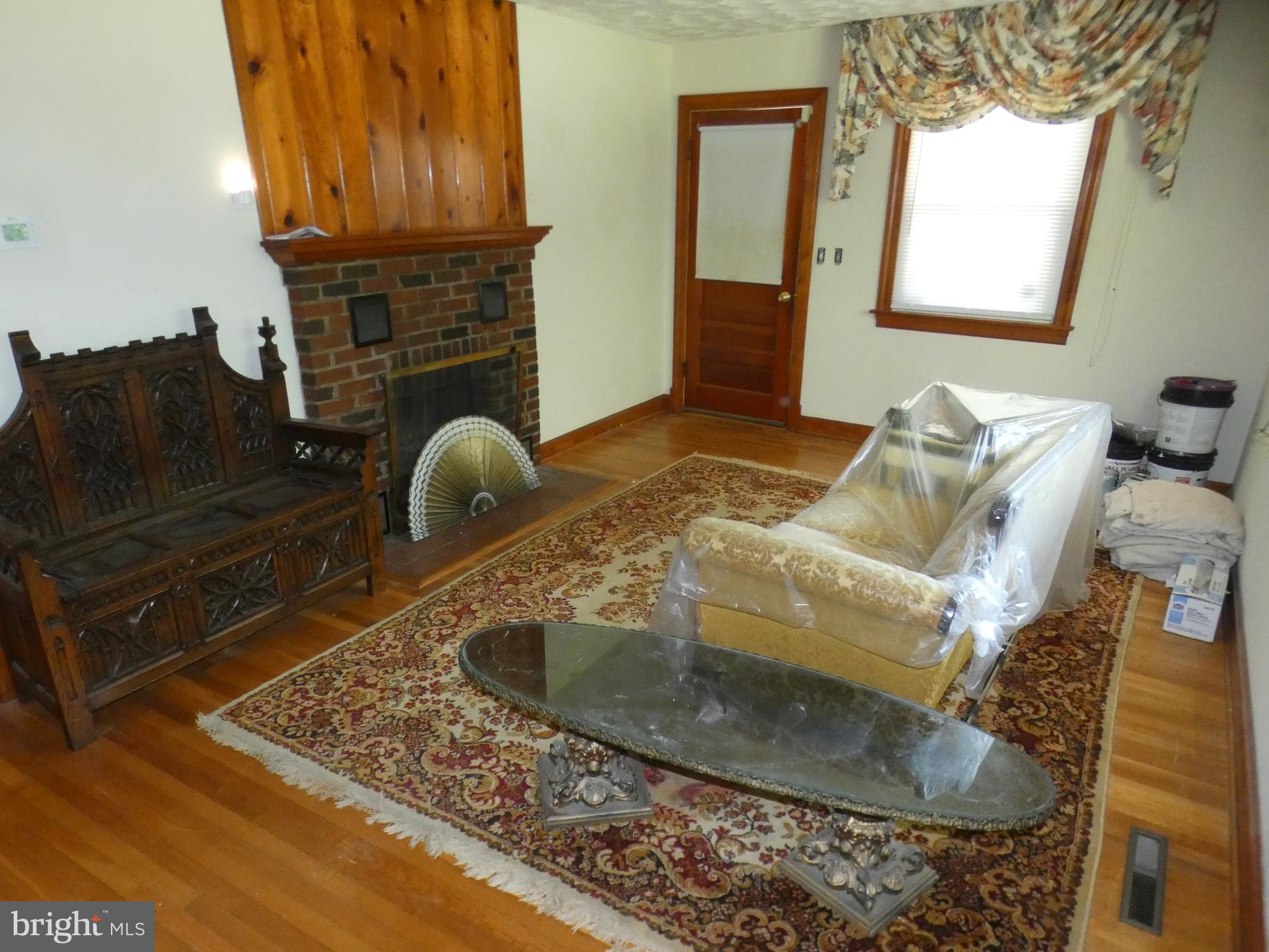 9517 Brock Road Spotsylvania, VA 22553 - Photo 3 of 27 a room with fireplace furniture and a wooden floor