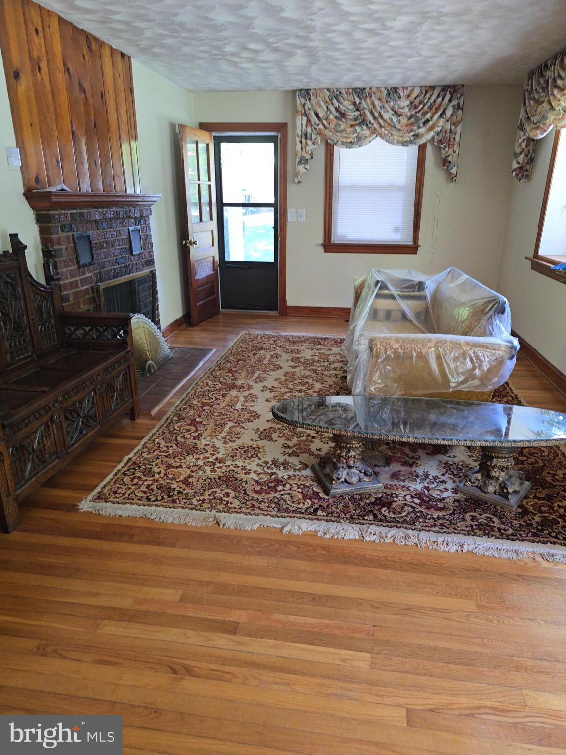9517 Brock Road Spotsylvania, VA 22553 - Photo 4 of 27 a living room with couch table and a fireplace