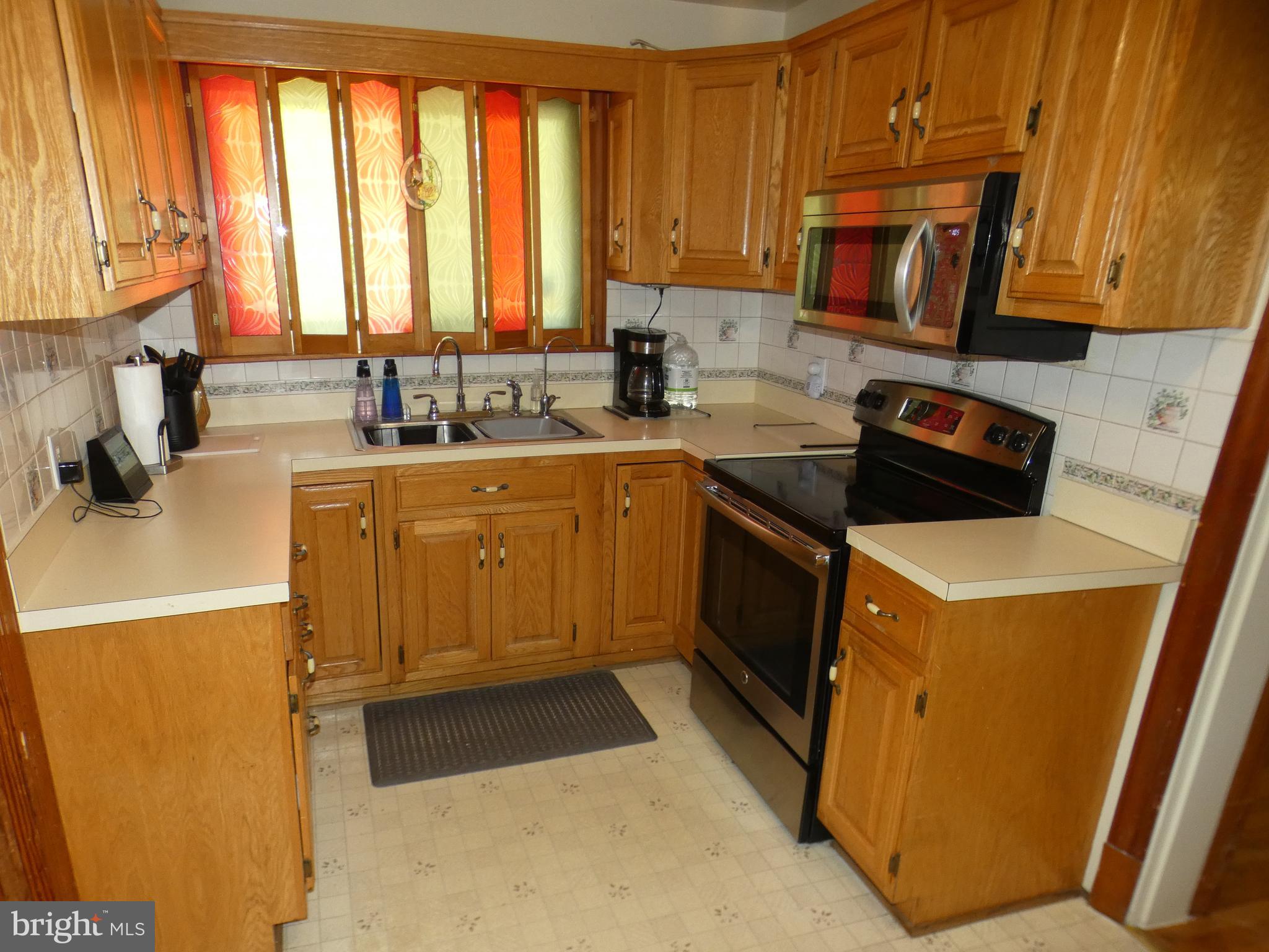 9517 Brock Road Spotsylvania, VA 22553 - Photo 10 of 27 a kitchen with a sink a stove and cabinets