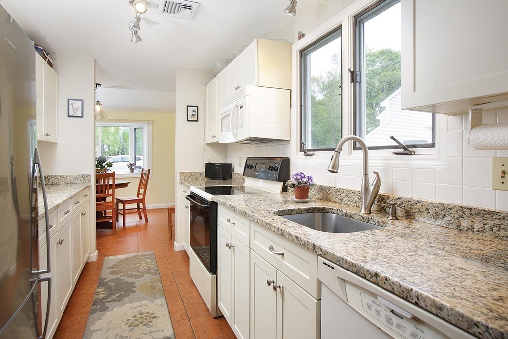50 Undine Road, Unit 5 Brighton, MA 02135 - Photo 3 of 11 a kitchen with a sink a counter top space appliances and a window
