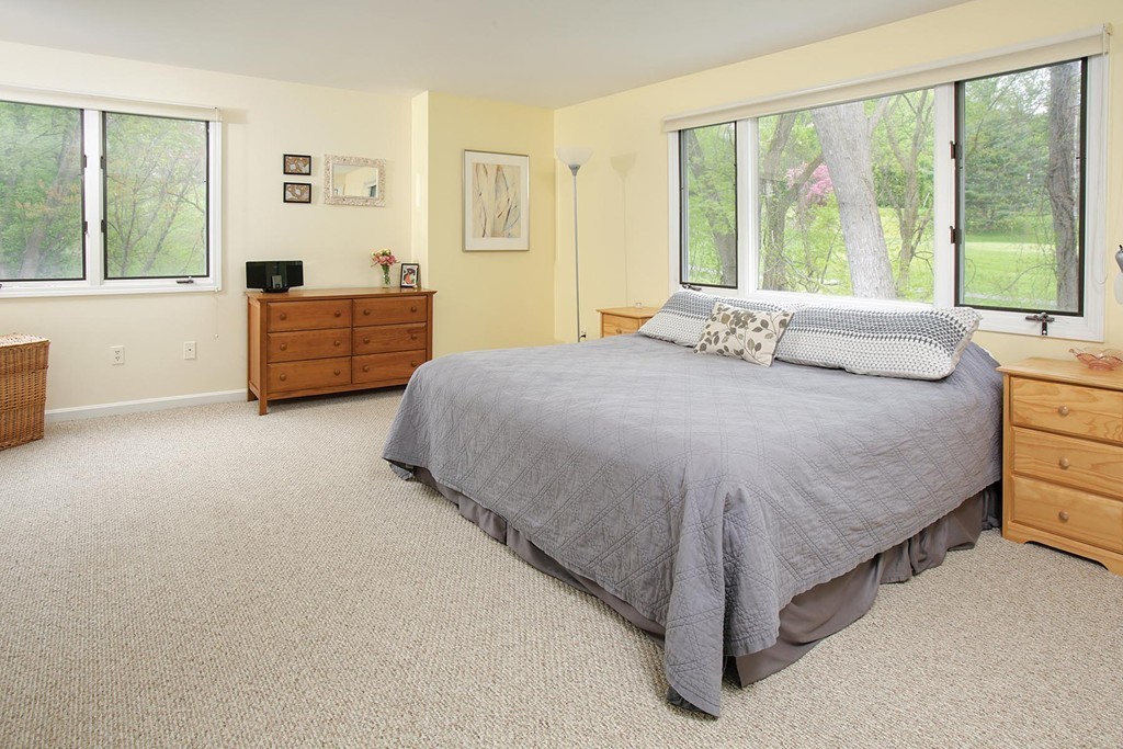 50 Undine Road, Unit 5 Brighton, MA 02135 - Photo 4 of 11 a bed sitting in a bedroom next to a window