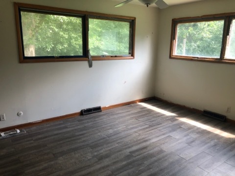 1600 Middletree Road Joliet, IL 60433 - Photo 14 of 22 a view of an empty room with wooden floor and windows