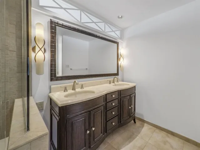 a bathroom with a double vanity sink and mirror