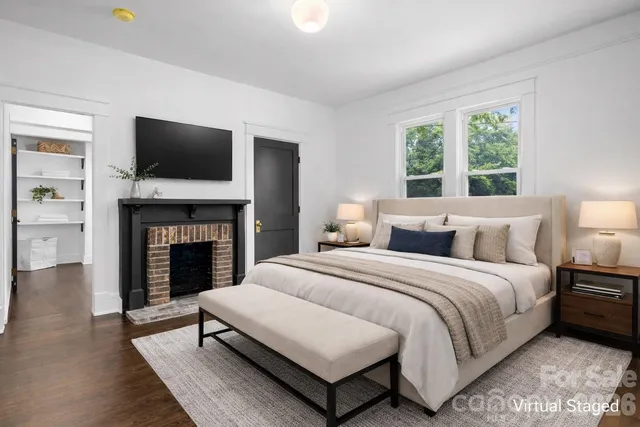 a spacious bedroom with a bed and a fireplace