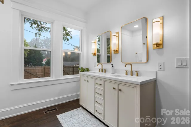 a spacious bathroom with a double vanity sink and a mirror