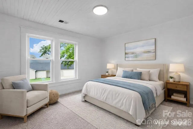 a bedroom with a bed and a couch