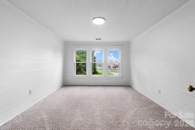 an empty room with windows and natural light