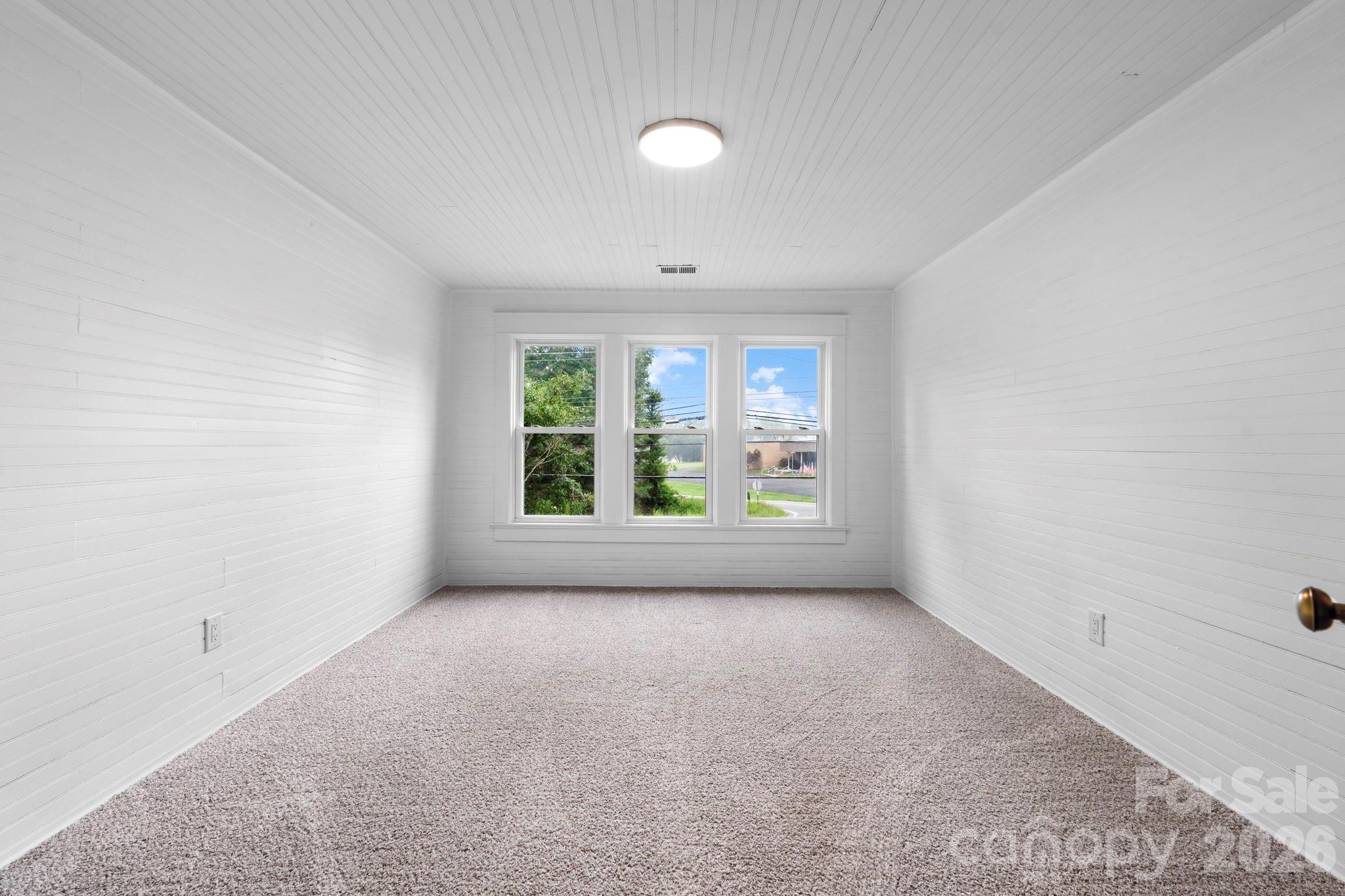 1590 South Center Street Hickory, NC 28602 - Photo 21 of 29 an empty room with windows and natural light
