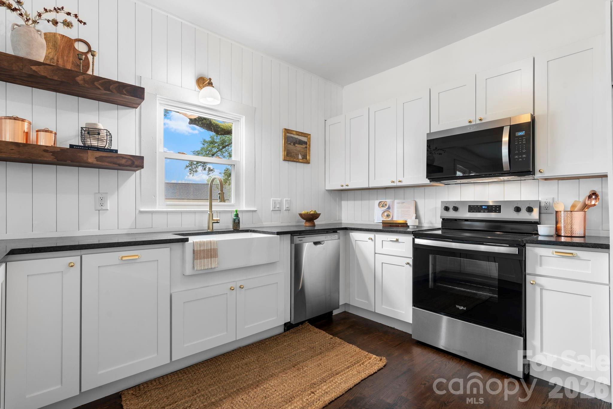 1590 South Center Street Hickory, NC 28602 - Photo 6 of 29 a kitchen with stainless steel appliances granite countertop a stove a sink and a microwave