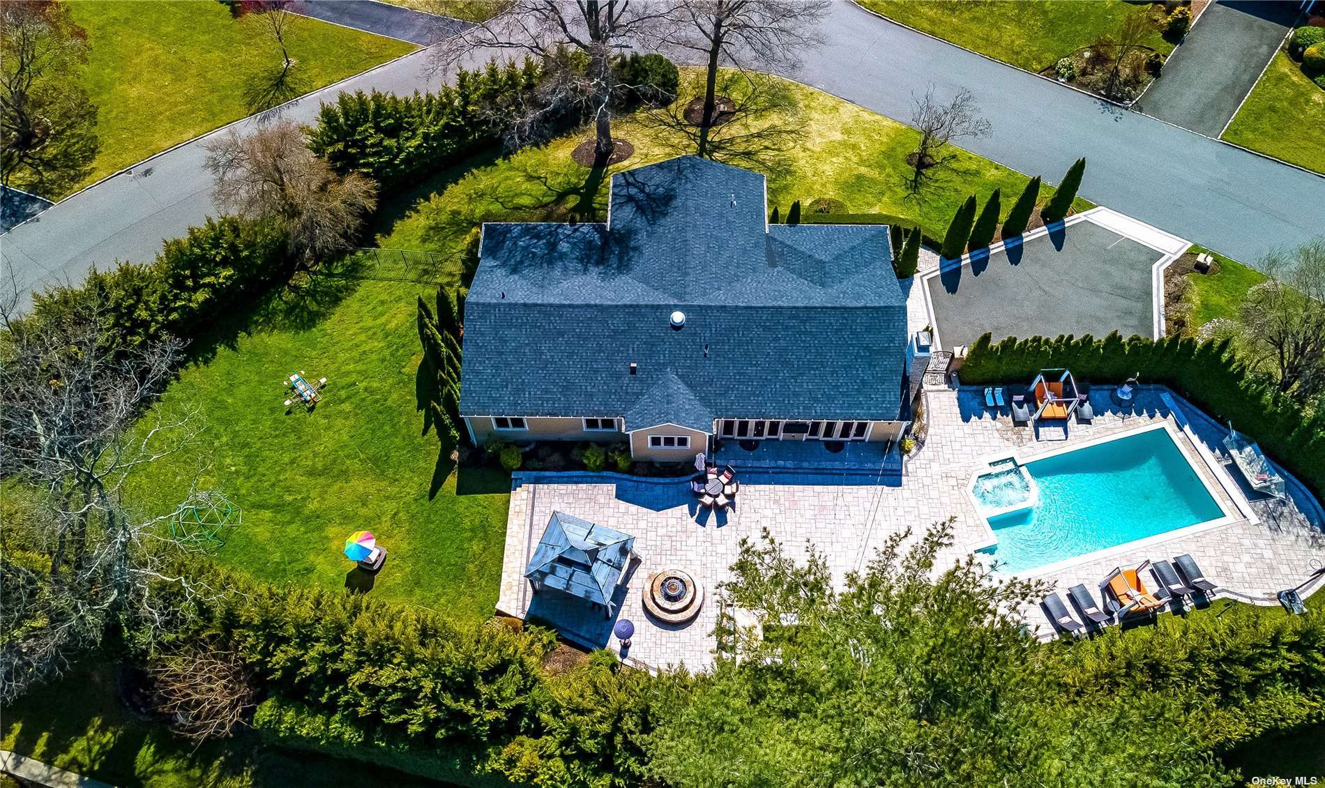 an aerial view of a house with a yard and a large pool