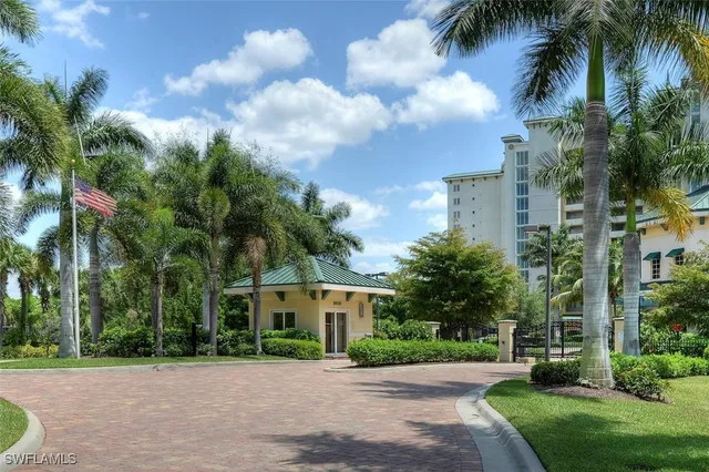 a front view of a house with a garden and trees