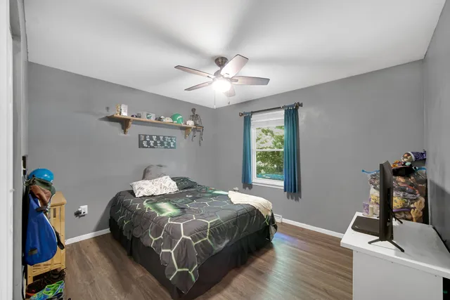 a bedroom with a bed and a chandelier