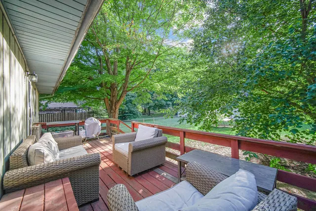 a view of a patio with couches chairs and wooden floor