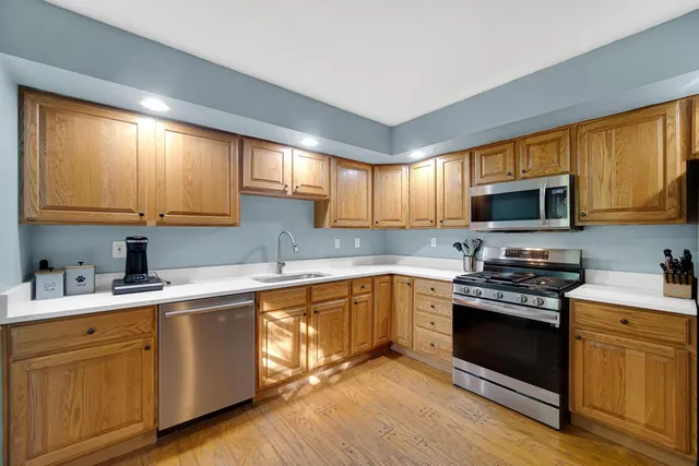a kitchen with a sink stove top oven and cabinets
