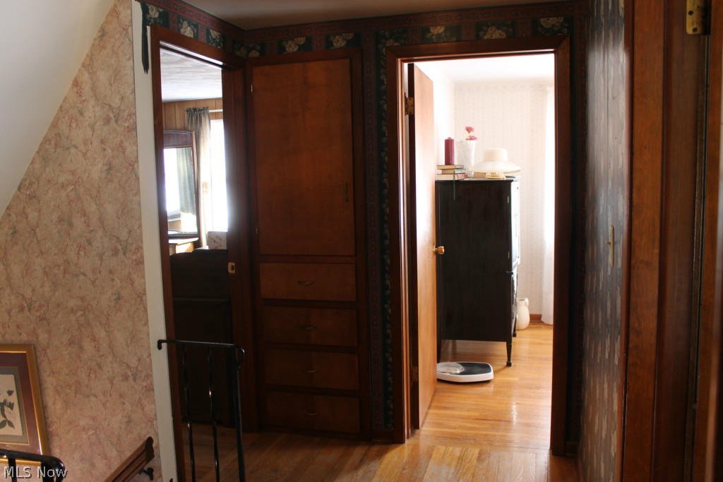 1999 Porter Road Atwater, OH 44201 - Photo 21 of 24 Hallway upstairs with beautiful hardwood floor and awesome built-ins!