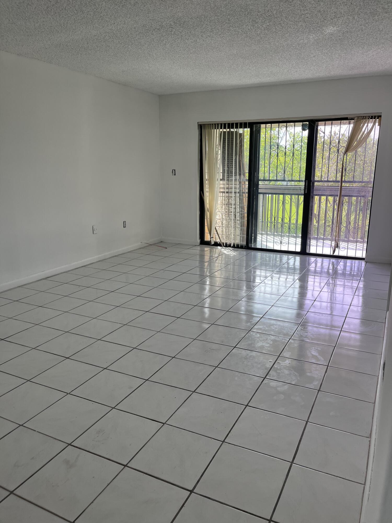 8879 Fontainebleau Boulevard, Unit 206 Miami, FL 33172 - Photo 5 of 7 a view of an empty room and window