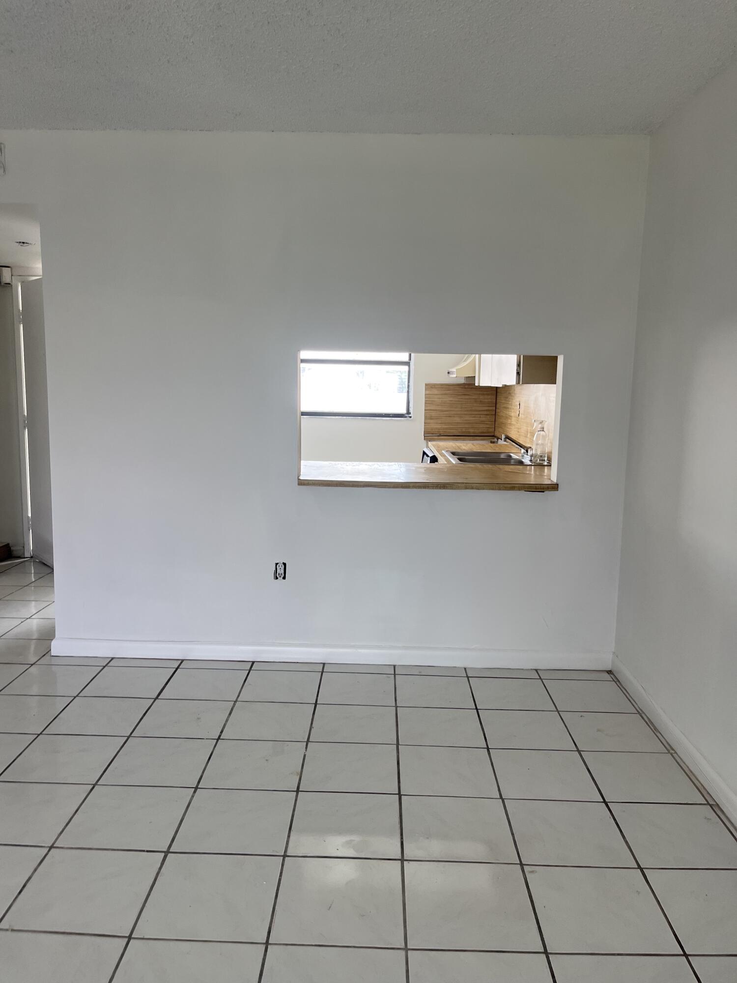 8879 Fontainebleau Boulevard, Unit 206 Miami, FL 33172 - Photo 6 of 7 a view of a livingroom with an empty space and a window