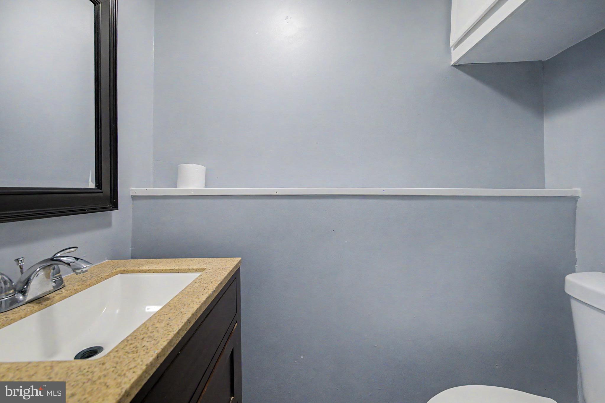 16 Malvern Road Newark, DE 19713 - Photo 28 of 35 a bathroom with a granite countertop sink and a toilet