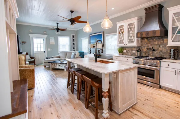 a kitchen with a stove a sink and a refrigerator