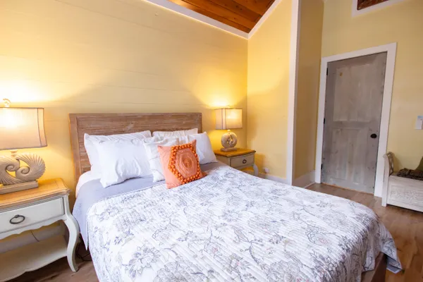 a bedroom with a bed and a lamp