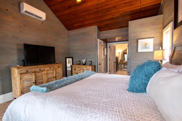 a bedroom with a bed and a flat screen tv