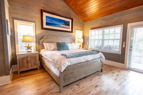 a spacious bedroom with a bed and a window