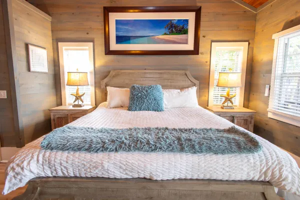 a bedroom with a large bed and a window