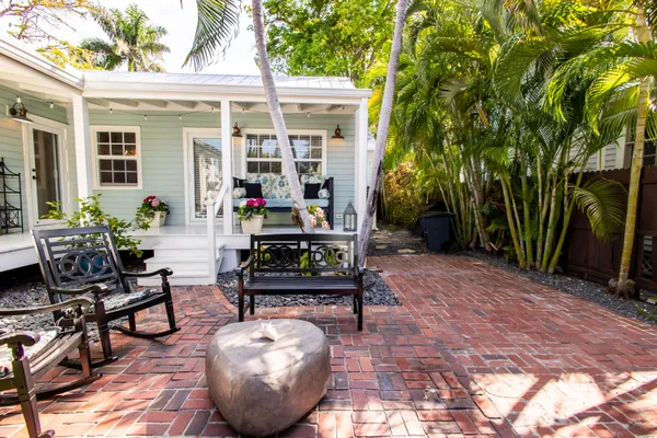 a backyard of a house with outdoor seating