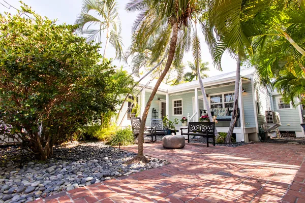 a front view of a house with outdoor seating