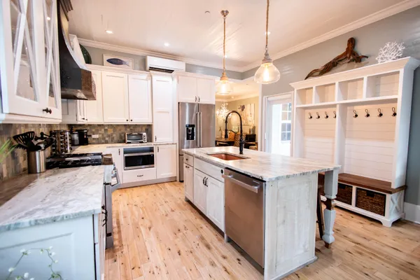 a kitchen with stainless steel appliances granite countertop a stove and a sink