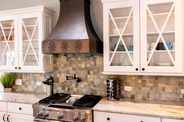 a kitchen with a stove and a white cabinet