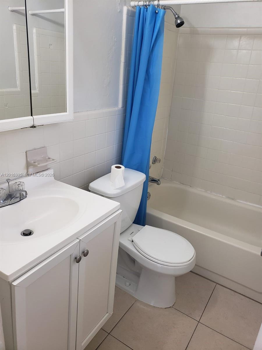 554 Northeast 68th Street, Unit 4 Miami, FL 33138 - Photo 15 of 15 a white toilet sitting next to a bathroom sink