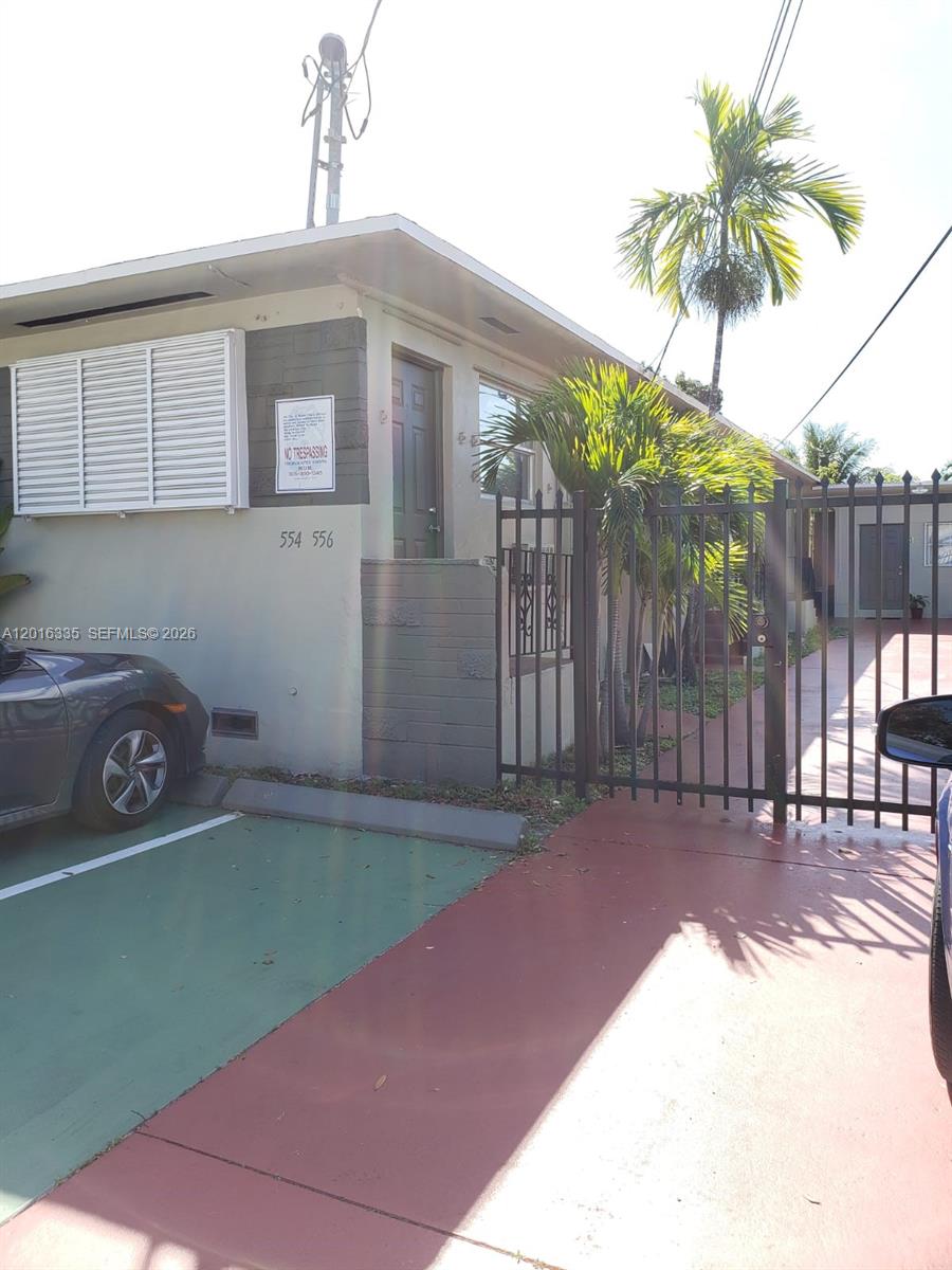 554 Northeast 68th Street, Unit 4 Miami, FL 33138 - Photo 5 of 15 a backyard of a house with table and chairs