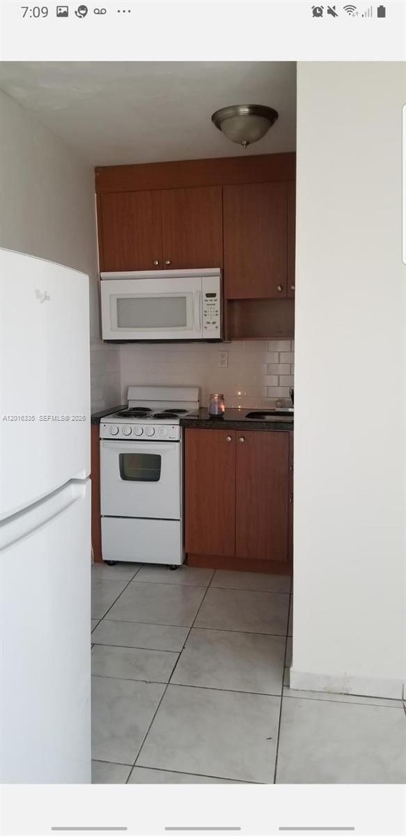 554 Northeast 68th Street, Unit 4 Miami, FL 33138 - Photo 9 of 15 a kitchen with a stove top oven