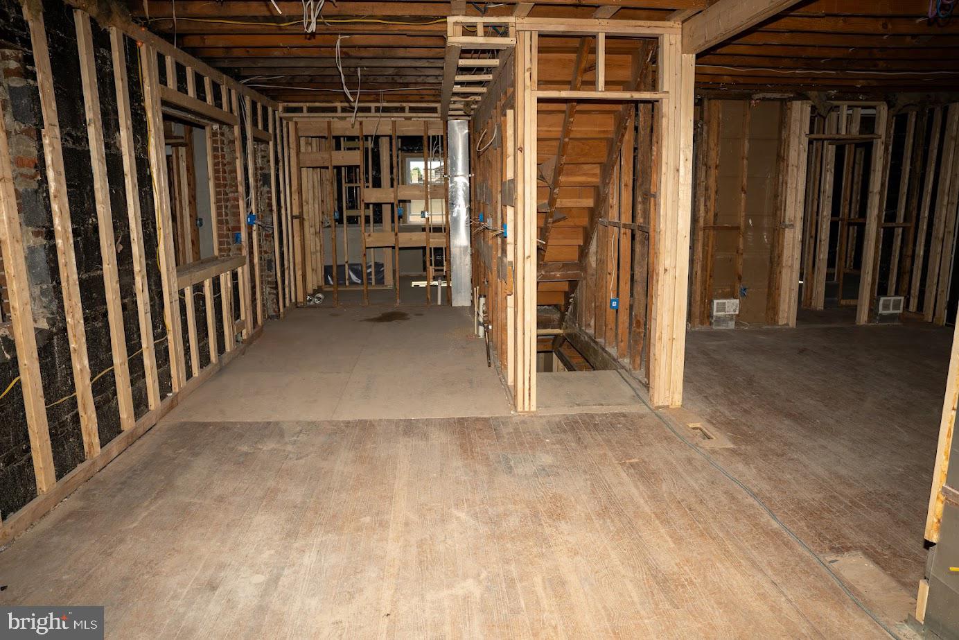 3704 Suitland Road Southeast Washington, DC 20020 - Photo 15 of 25 a view of empty room with wooden floor and stairs